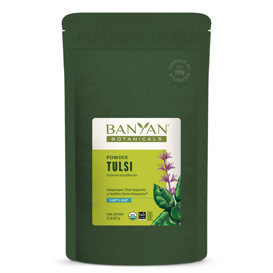 Green pouch of Banyan Botanicals Tulsi powder on a white background